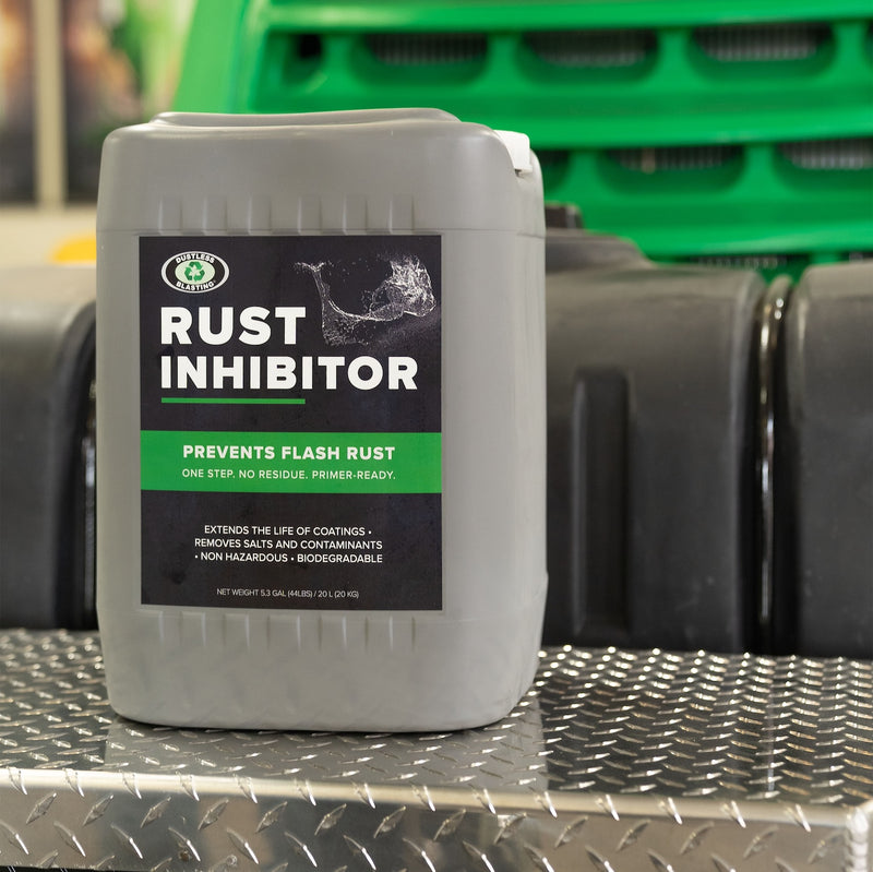 5 gal Dustless Blasting Rust Inhibitor container sitting on a mobile machine.